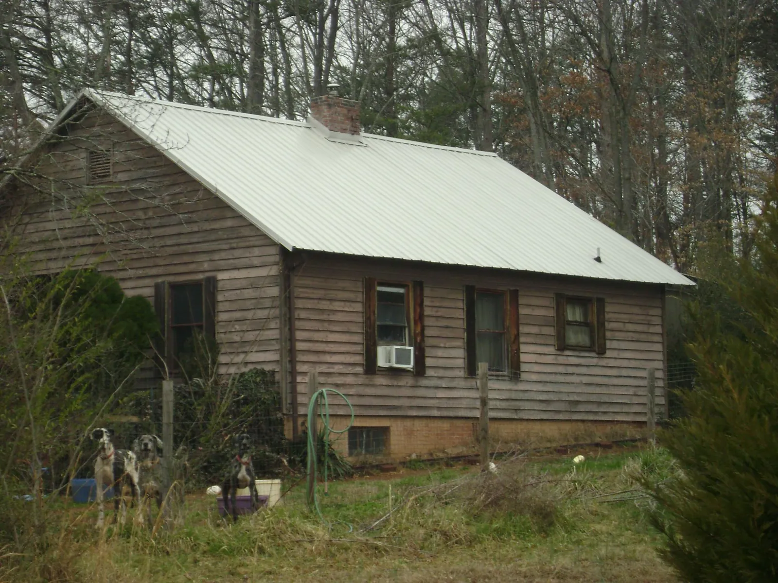 White metal roof on an old wood sided farmhouse, from a Metal Roof Installation job in Cusick